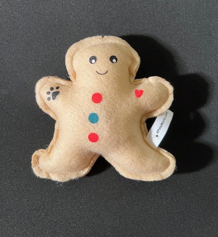 Gingerbread soft dog toy with squeaker on black background