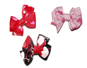 Dog hair accessories with unique prints, hearts and beads for Valentine's day.  Choose from Barrettes and elastics for male and female dogs. 