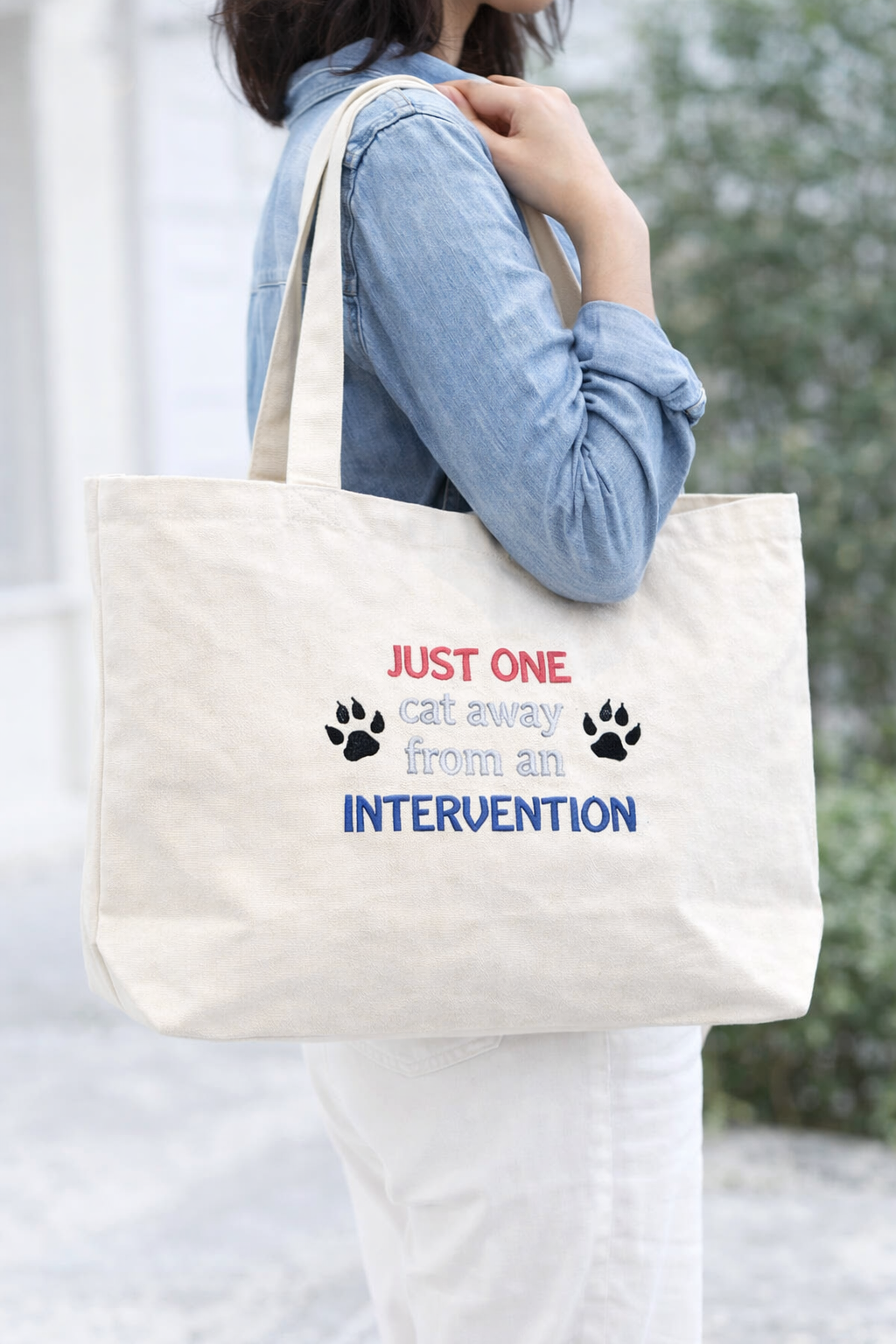 model shot of cat intervention canvas  tote with embroidery for Cat lovers