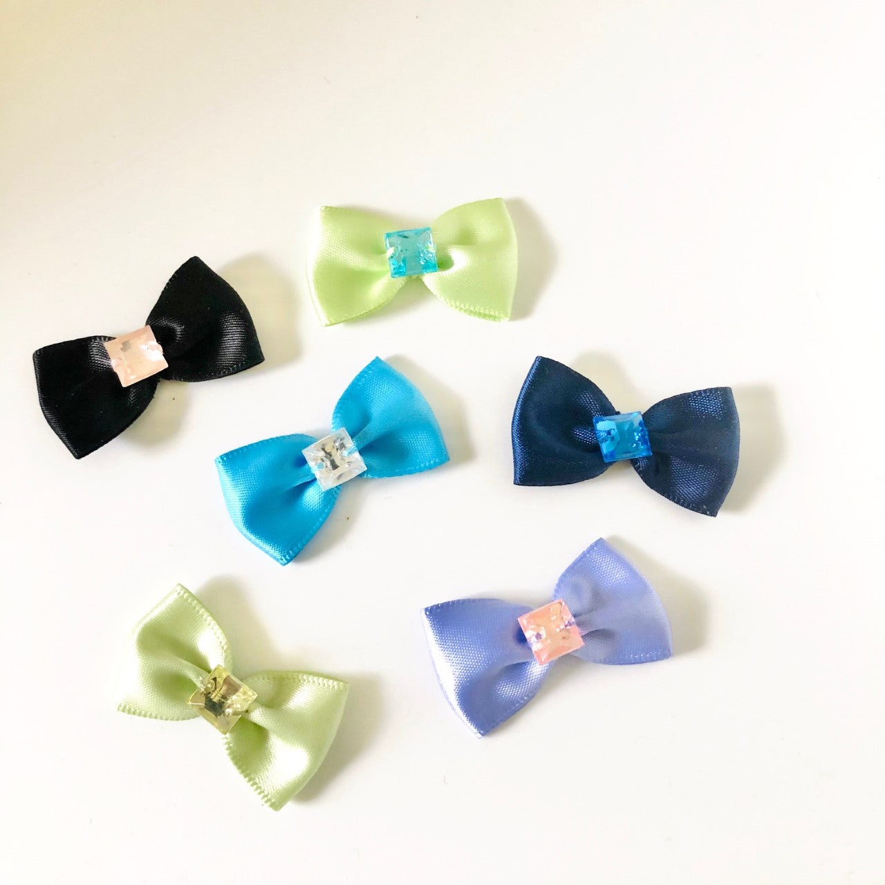 Single square Gemstones of different colors on satin bows in several colors